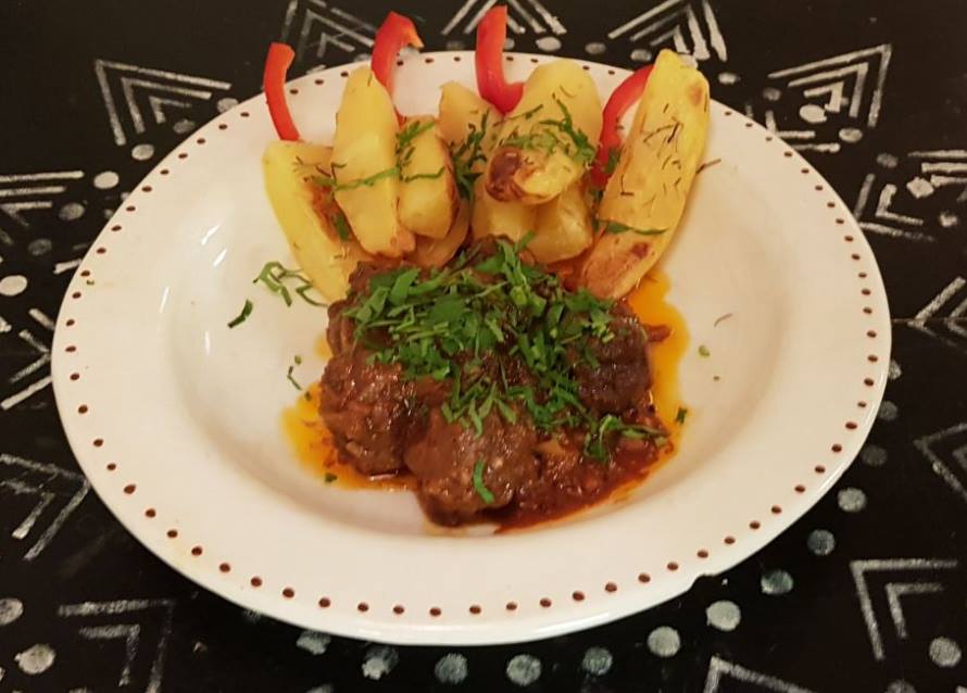 Minced beef balls with pomegranate, cumin, coriander, thyme, and black pepper with baked potatoes and rosemary.jpg