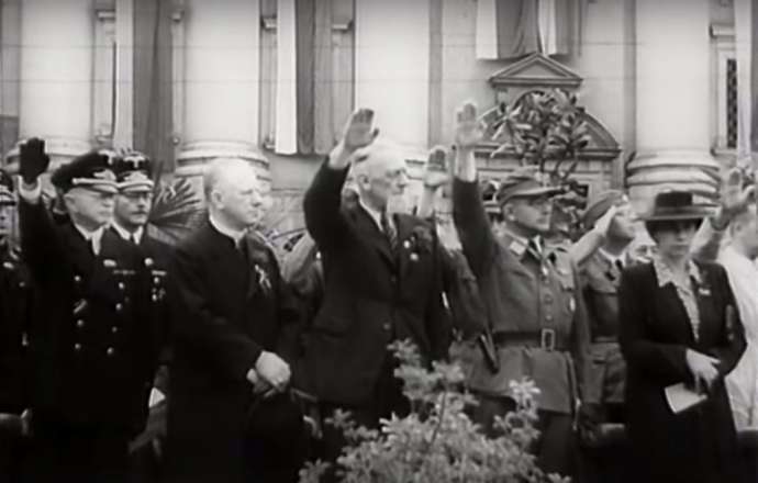 Leon Rupnik saluting the Nazi flag, after being the main speaker at a pro-Nazi rally in front of the Ursuline Church of the Holy Trinity, Kongresni trg, Ljubljana